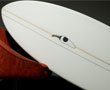 Name: Black Pepper -This board has everything you expect from a traditional Fish. Shortened length to fit better in the shape of small waves; width creates more surface area which helps to glide through flat sections; thickness offers buoyancy which helps paddling and planing speed. It’s the rocker/bottom curve combination that sets the Peppa apart from the rest. Built on a constant rocker with deep concave for speed & lift. The concave naturally creates a straighter stringer line (rocker) which planes more efficiently between turning off the maintained curve in the rail line (rocker). Ride around 6 inches shorter. Image by Chilli Surfboards