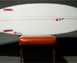 Name: Red Pepper - Low fast entry to get through flat sections. A deep double concave which keeps transition from rail to rail very smooth. The rounded square v-tail in conjunction with the 3 inch flat panels out on each rail stabilizes and narrows the water flow under your board keeping speed. Image by Chilli Surfboards