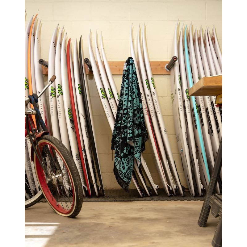 LEUS Conner Coffin Beach Towel hanging on surfboards