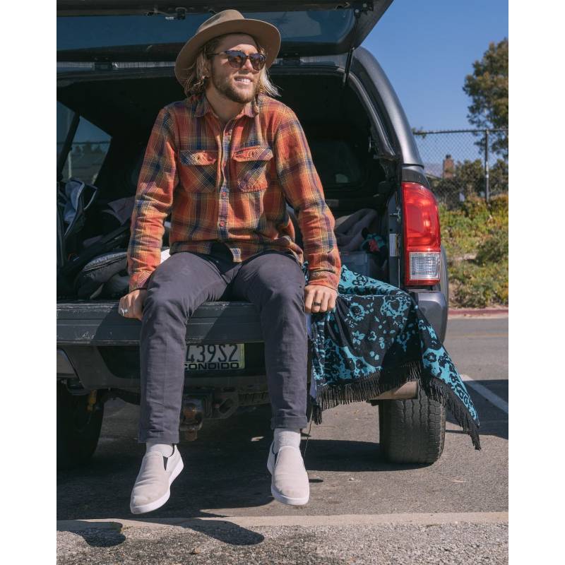 Conner Coffin sitting on tail gate with LEUS Beach Towel