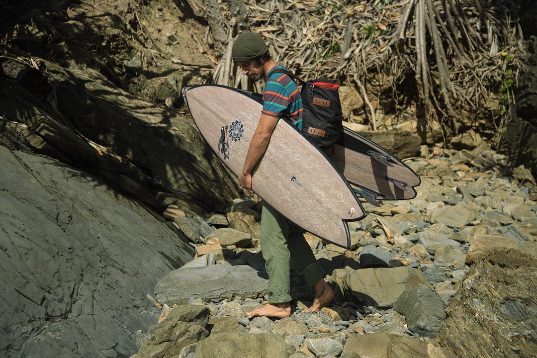 Dave Rastovich holding a Flax Surfboard eco board by Gary McNeill